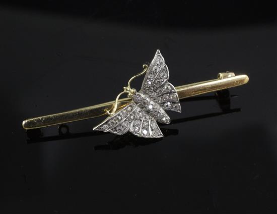 An Edwardian 15ct gold and diamond set butterfly bar brooch, 50mm.